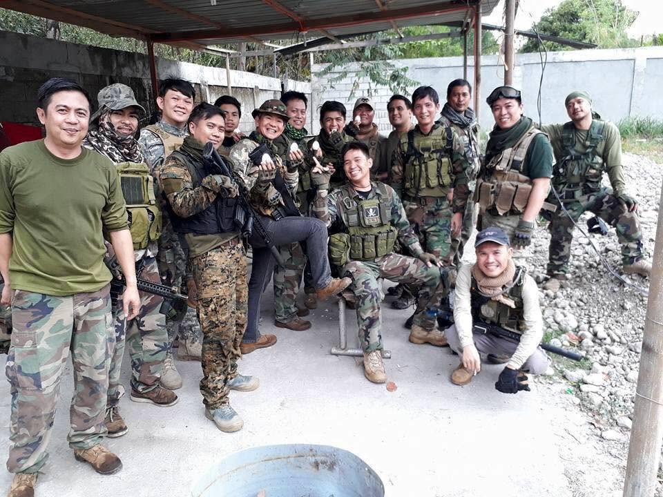 Members relax under a covered area between rounds.