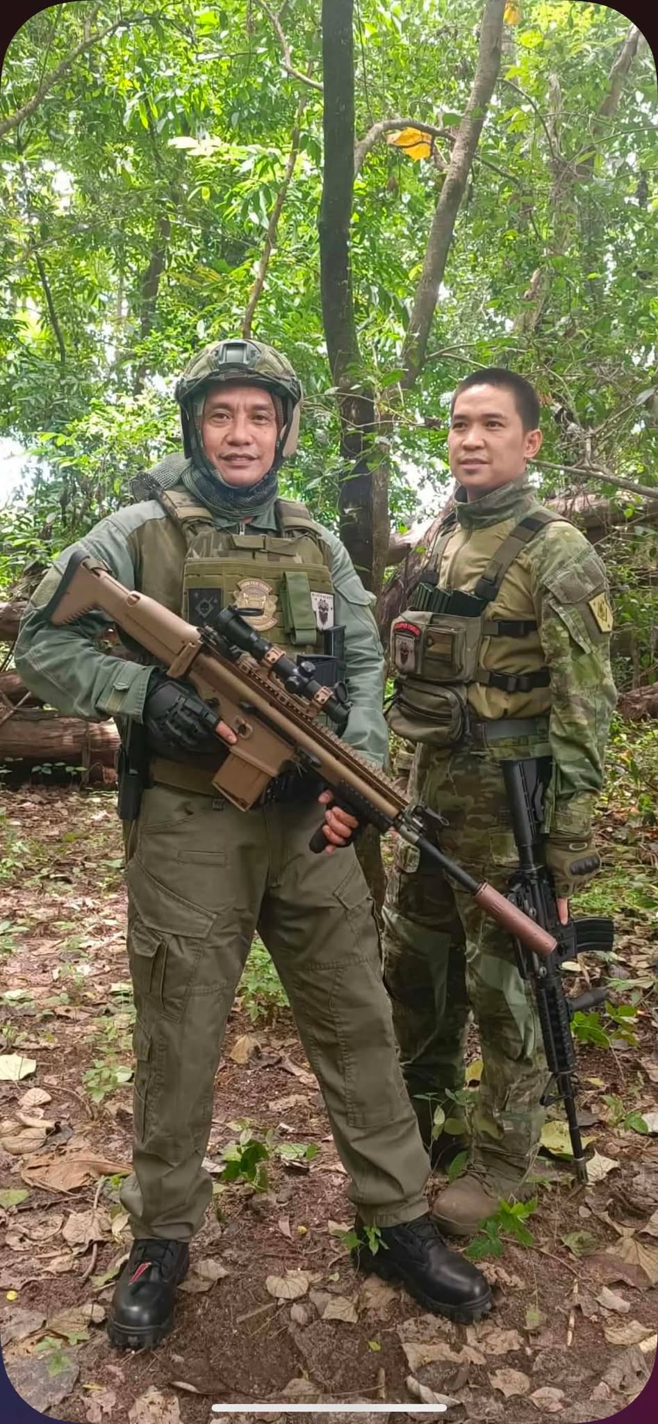 Two members pause for a photo mid-mission in the jungle.