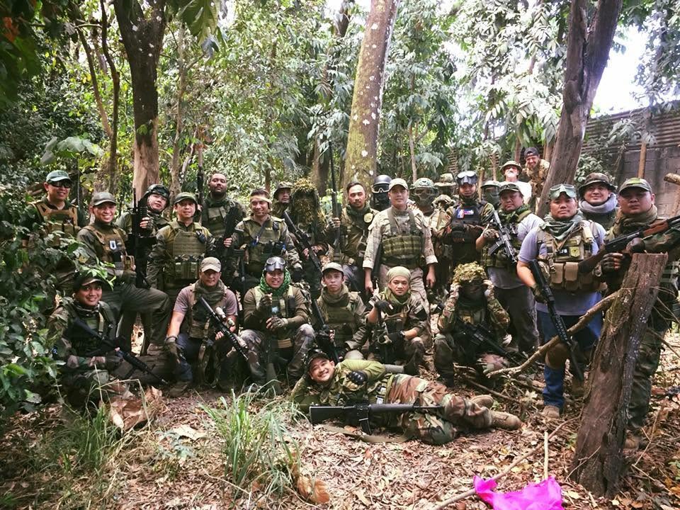The squad gathers among the trees during a jungle operation.